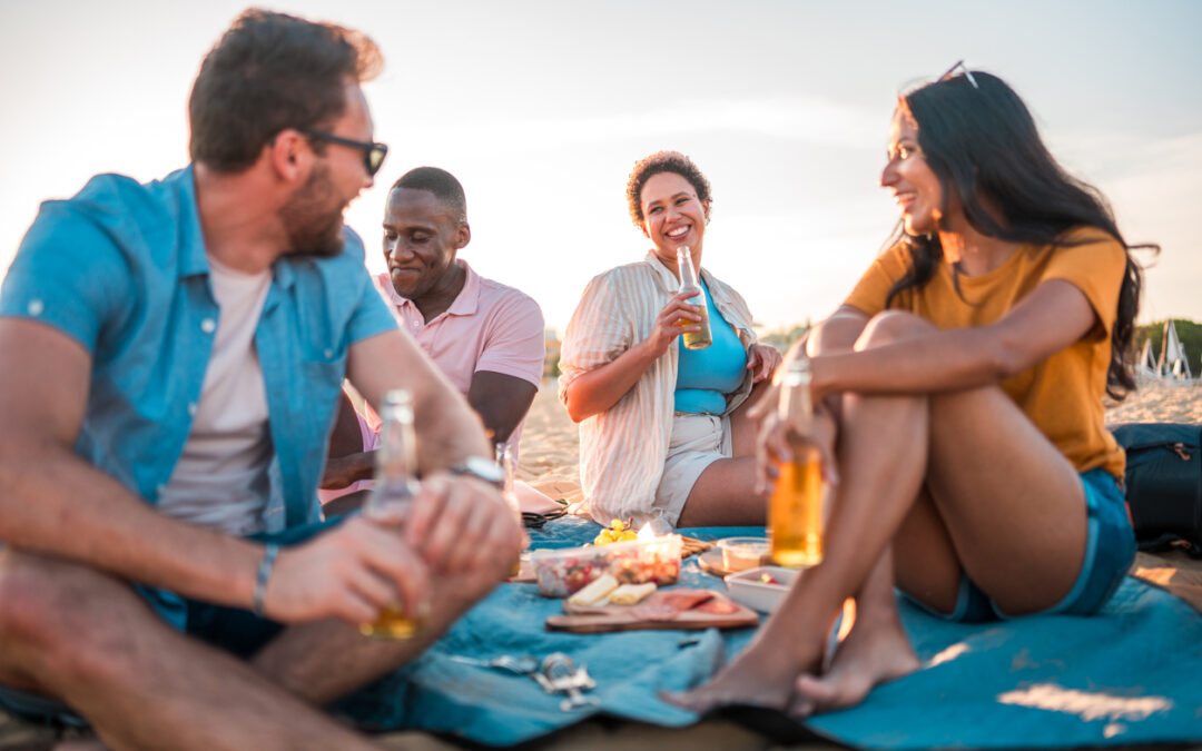 Summer party ideas - A group of friends having a picnic by the beach.